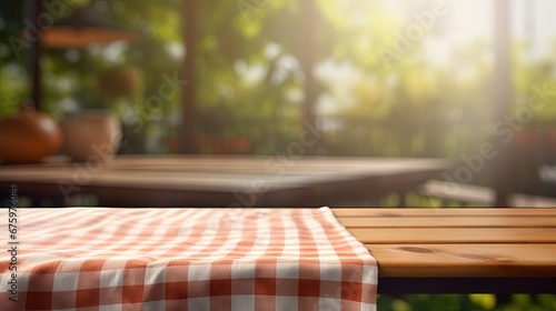 Checkered towel on wooden table blurred kitchen background. Picnic cloth empty space tabletop.
