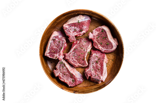 Raw lamb loin rib chops steaks in wooden plate with herbs. Transparent background. Isolated