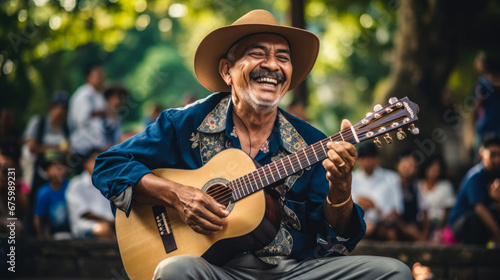 Happy Hispanic man playing guitar in a public park in Colombia
