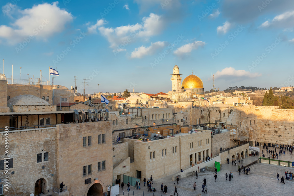 Obraz premium The old city of Jerusalem at sunset, including the Western Wall and golden Dome of the Rock, Jerusalem, Israel.