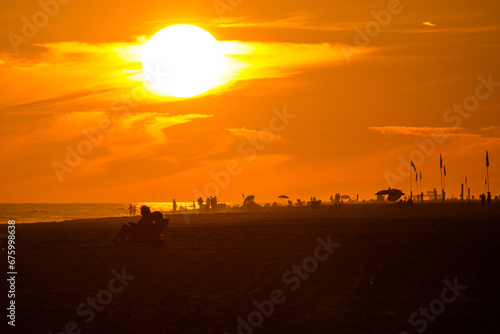 sunset on the beach with people © ChuckS