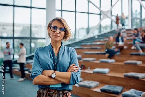 Cuadro en lienzo Confident businesswoman during education event at convention center looking at camera