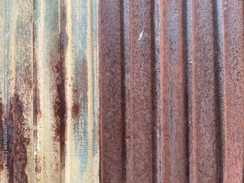 Old and rusty galvanized sheet walls, vintage style metal sheet roof. Pattern of old metal plate Rusting of metal or walls