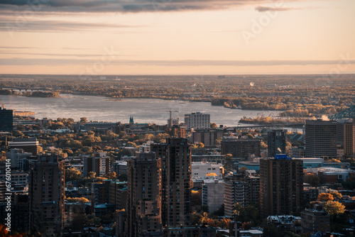 Panoramic view of the Skyscrapers of Montreal at sunrise from Mont Royal, Business centre and skyscrapers warm light finance centers banks money view of the San Lorenzo river © legedo