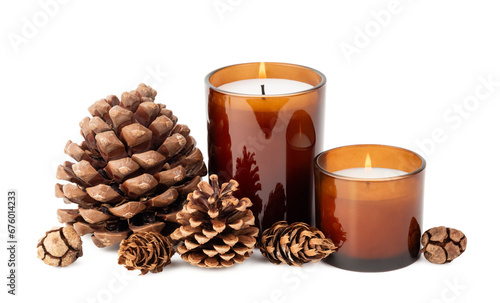 natural Christmas / holiday decoration design element, various pine and cypress cones and two burning candles in amber glass jars isolated over a transparent background, eco friendly home decor, PNG