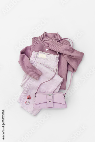 Fashion spring or summer outfit. Purple jumper and jeans with handbag. Women's stylish and elegant clothes with accessory and jewelry. Fashionable look. Flat lay, top view, overhead.