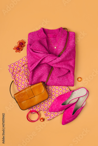 Fashion spring or autumn outfit. Pink jumper and shoes with pants, handbag. Women's stylish and elegant clothes with accessory and jewelry. Fashionable look. Flat lay, top view, overhead.