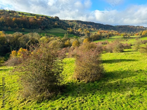 Autumn landscape, looking across Shibden Valley, with trees, farms, and hills near, Halifax, UK photo