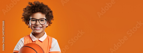 cute kid holding basketball on orange background, generative ai