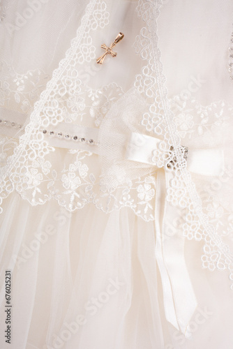 Close up of baby baptism dress with cross
