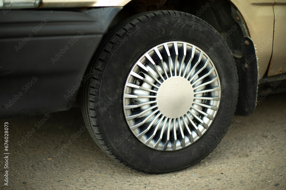 Car wheel. Hubcap on wheel. Vehicle tuning details. Drive wheel. Retro style. Car wheel. Hubcap on wheel. Vehicle tuning details. Drive wheel. Retro style.