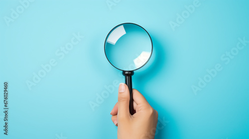 Hand holding magnifier glass