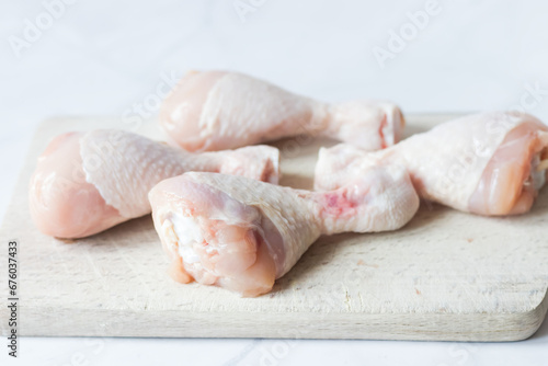 Raw chicken legs with spices and herbs. on a white background. food