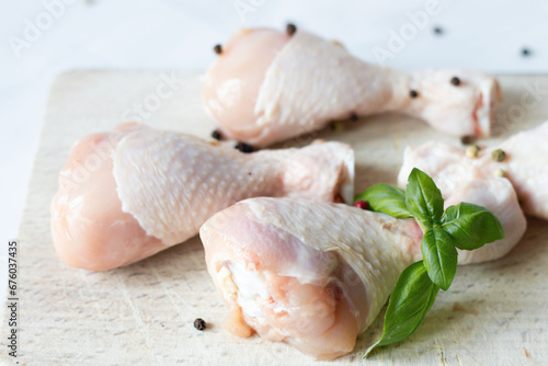 Raw chicken legs with spices and herbs. on a white background. food