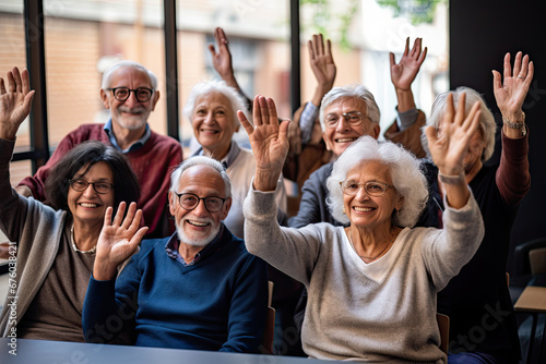 A mixed ethnic group of retired elderly senior citizens adults raising hands with questions with a smile photo