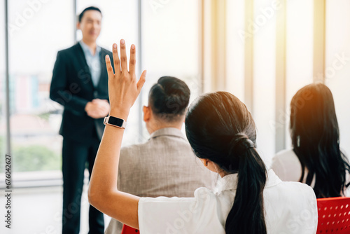Conference attendees raise their hands for questions, showcasing interactive engagement. A diverse audience collaborates at a workshop or seminar, highlighting teamwork and discussion.