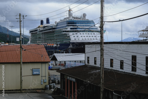 Street city view with wooden houses, shops, cars and mountain wilderness nature in Ketchikan, Alaska, popular cruise destination for whale watching in wildlife tours
