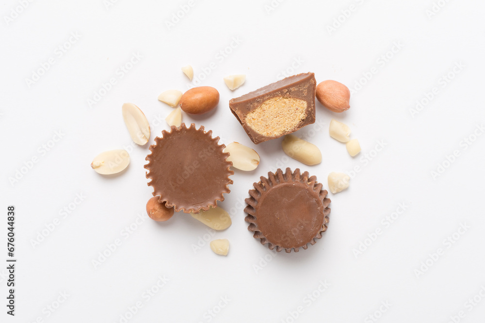 Tasty chocolate peanut butter cups on color background, top view