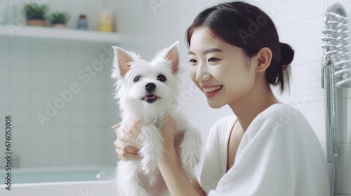 Photographie Content young Asian woman playing ball games with her adorable, fluffy Jack Russell terrier puppies at home; side view; copy space