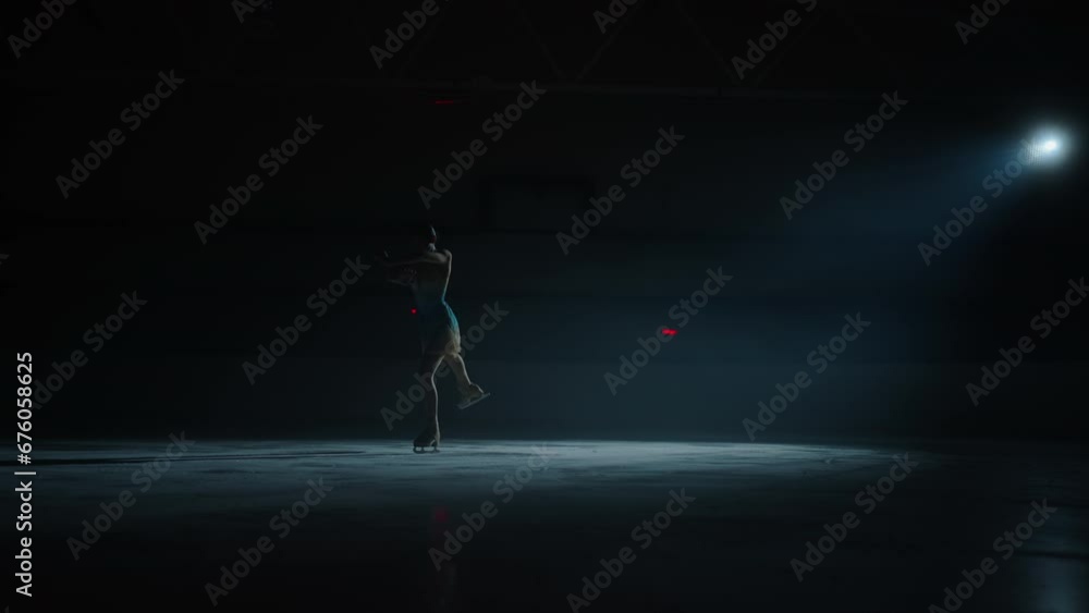 Silhouette Of Beautiful Woman Dancing On Ice, Female Figure Skater Skating In Darkness, Slow Motion Silhouette Of Beautiful Woman Dancing On Ice, Female Figure Skater Skating In Darkness, Slow Motion