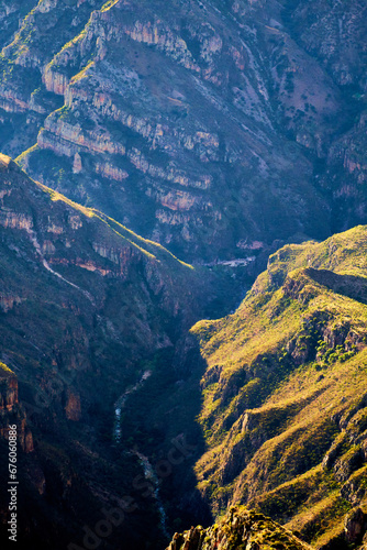 River in valley between mountains in Barrancas de la Sinforosa Guachochi Chihuahua photo