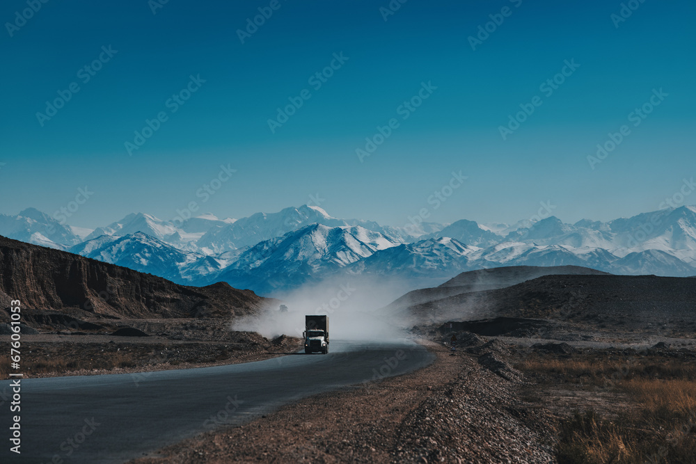 Truck on high mountains road, dramatic colors Truck on high mountains road, dramatic colors