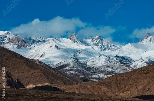 Beautiful landscape with snowy mountains in autumn © chaossart