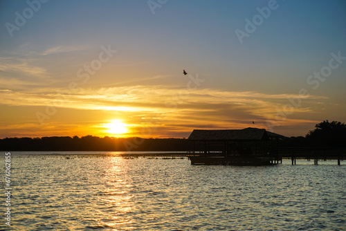 Beautiful sunset in Sucuriú River, with birds flying. Três Lagoas, Mato Grosso do Sul, Brazil photo