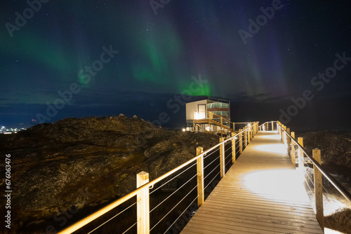 Northern Lights in Ilulissat.
Arctic Greenland.
Picturesque village on coast of Greenland with Aurora Borealis 