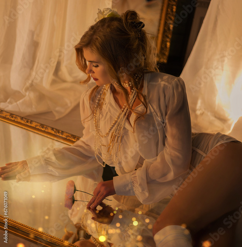 Aristocratic beautiful woman wearing corset speaking by vintage phone and sitting on luxury retro bed