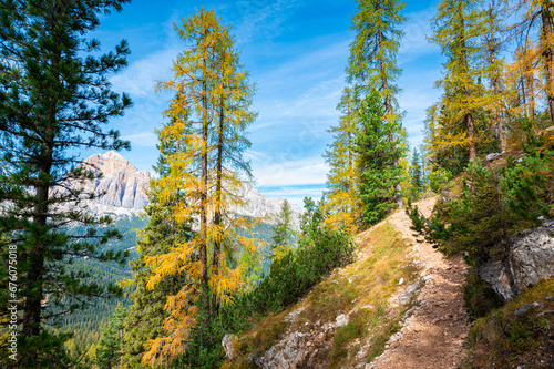 Hiking trail along a mountainside in the Ampezzo Dolomites, Italy on a sunny day in October