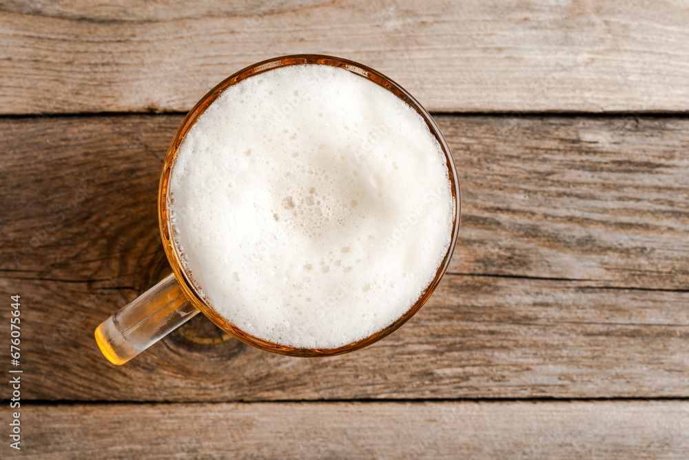 Beer glass on an old wooden table. Beer glass on an old wooden table.