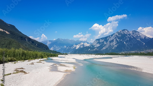 Scenic view of braided river Tagliamento running through mountainous landscape with in Friuli-Venezia Giulia, Italy, Europe. Clear blue water flowing in natural wilderness. Peaceful serene scene