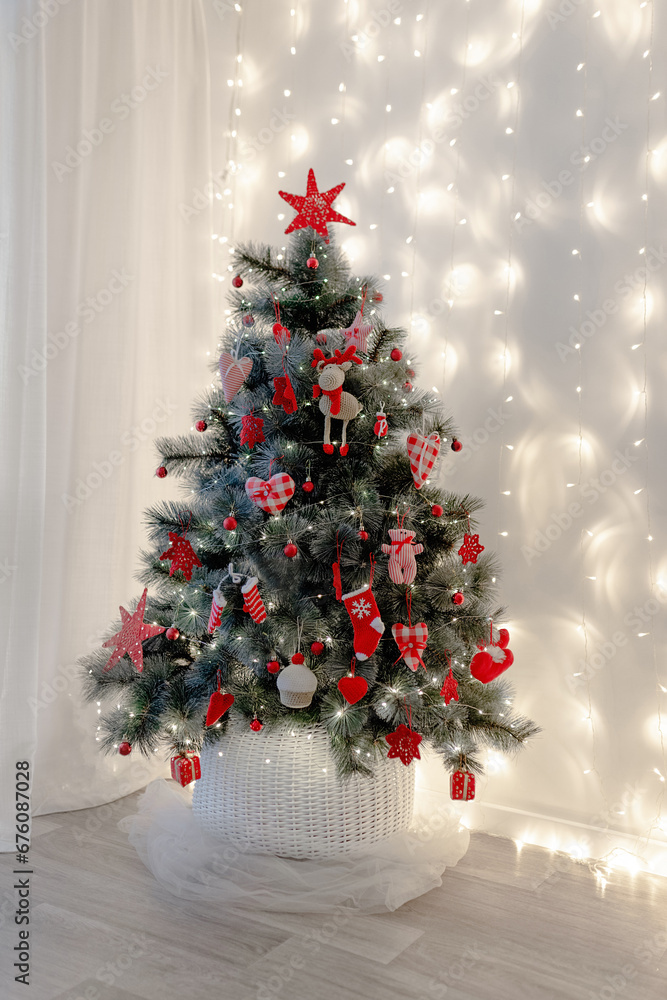 A Christmas tree decorated with red decor