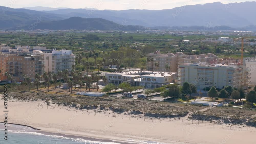 Aerial drone view of the coastal town with apartment buildings in Daimus Spain Aerial drone view of the coastal town with apartment buildings in Daimus Spain