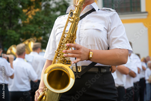 Military musician with a saxophone in her hand photo
