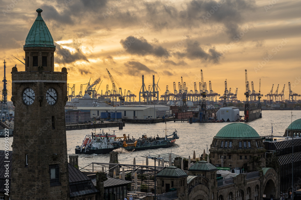 Creanes in the Hamburg Harbour at sunset, Germany
