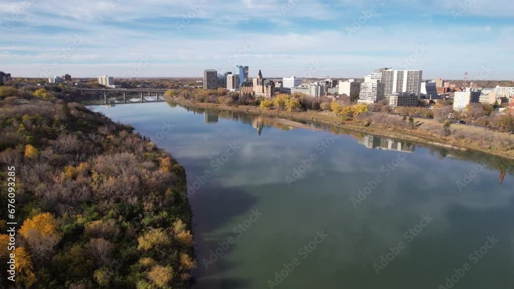 Aerial video of Saskatoon's downtown central business district, SK, Canada. Skyline view reveals bustling urban life, commercial buildings, and roads. Ideal for business concepts.