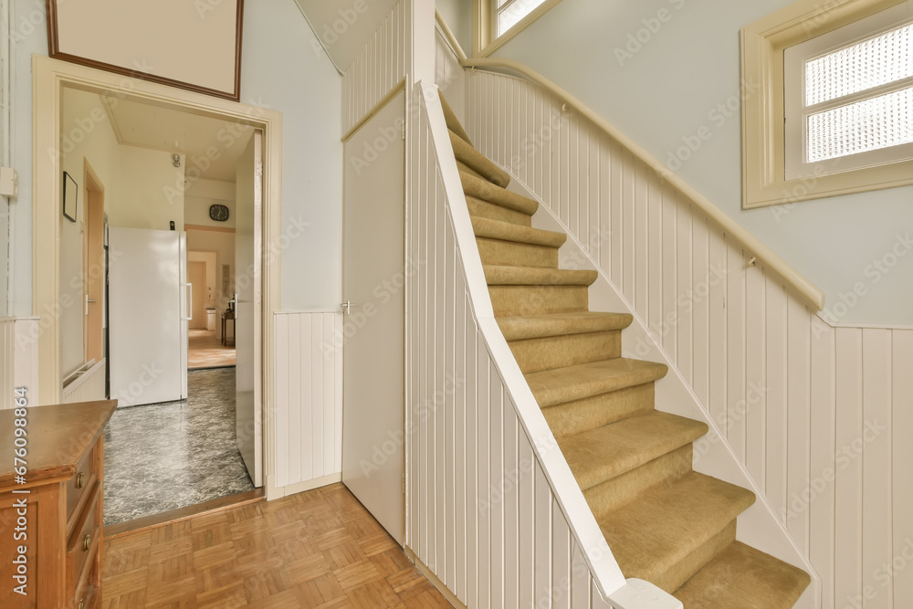 a staircase leading up to the second floor in a new home with wood floors and white panelling on the walls a staircase leading up to the second floor in a new home with wood floors and white panelling on the walls