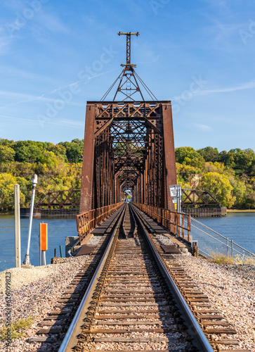 Historic Dubuque railroad bridge between Iowa and Illinois across the Mississippi river with swing span open for shipping