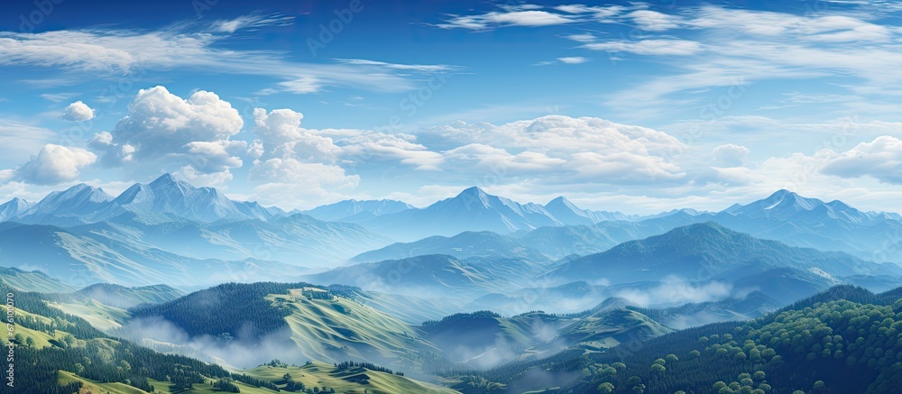 The blue sky offers a breathtaking view of the mountain landscape with rolling hills adding to the beauty of nature