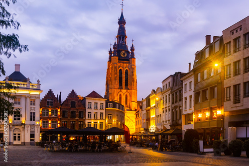 Night view of medieval gothic Saint Martins church and old buildings on Grote Markt, main square of Kortrijk, Belgium