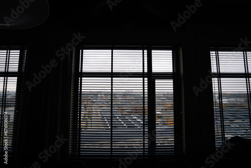 Looking through the blinds on industrial city