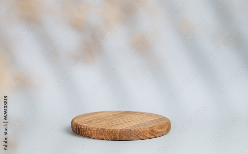 Abstract empty wooden board with shadows leaves on a gray background. Layout concept for promotional product presentation, sale or cosmetics display. Abstract empty wooden board with shadows leaves on a gray background. Layout concept for promotional product presentation, sale or cosmetics display.