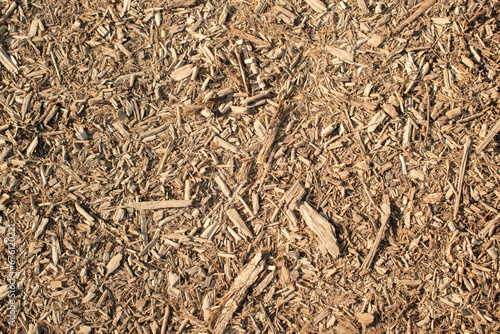 Brown woodchip mulch background or texture. Gardening, playground, parks, paths, texture, natural. 