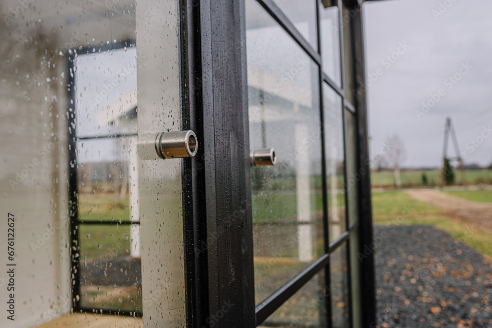 Blurred rain drops through glass door Blurred rain drops through glass door