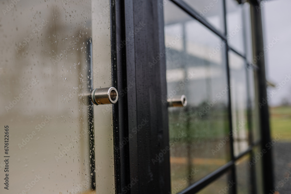 Blurred rain drops through glass door Blurred rain drops through glass door