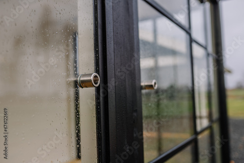 Blurred rain drops through glass door