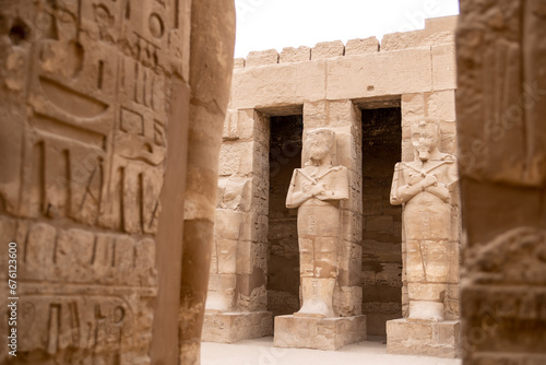 series of pharoahic statues in hallway of Karnak Temple in Luxor Egypt