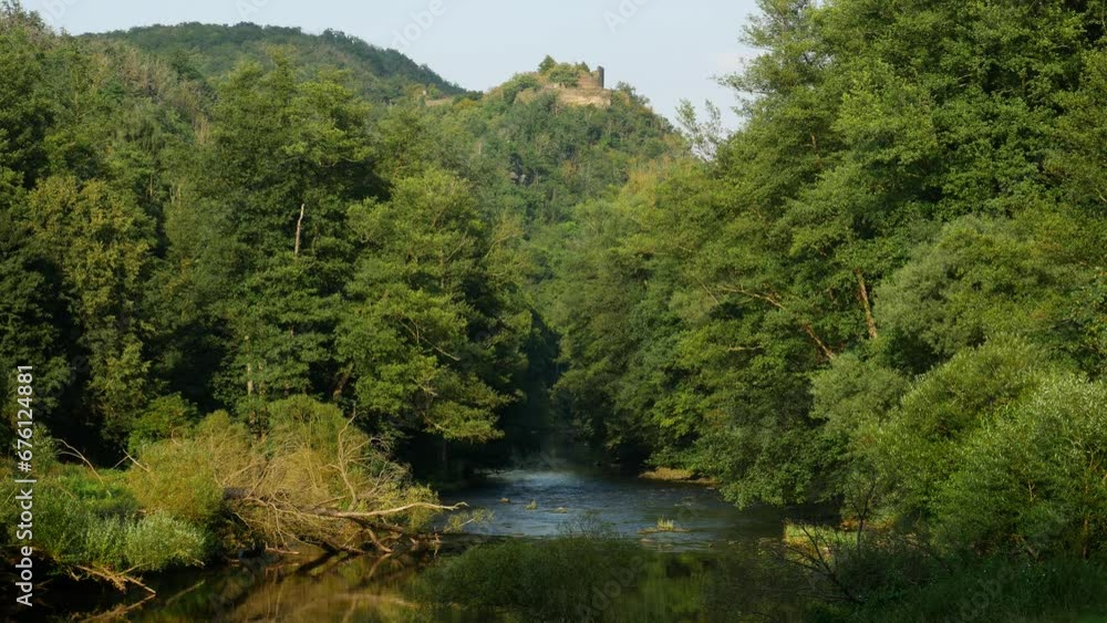 Castle Seen from a Beautiful Lush Forest Valley Wilderness in Europe in September Castle Seen from a Beautiful Lush Forest Valley Wilderness in Europe in September